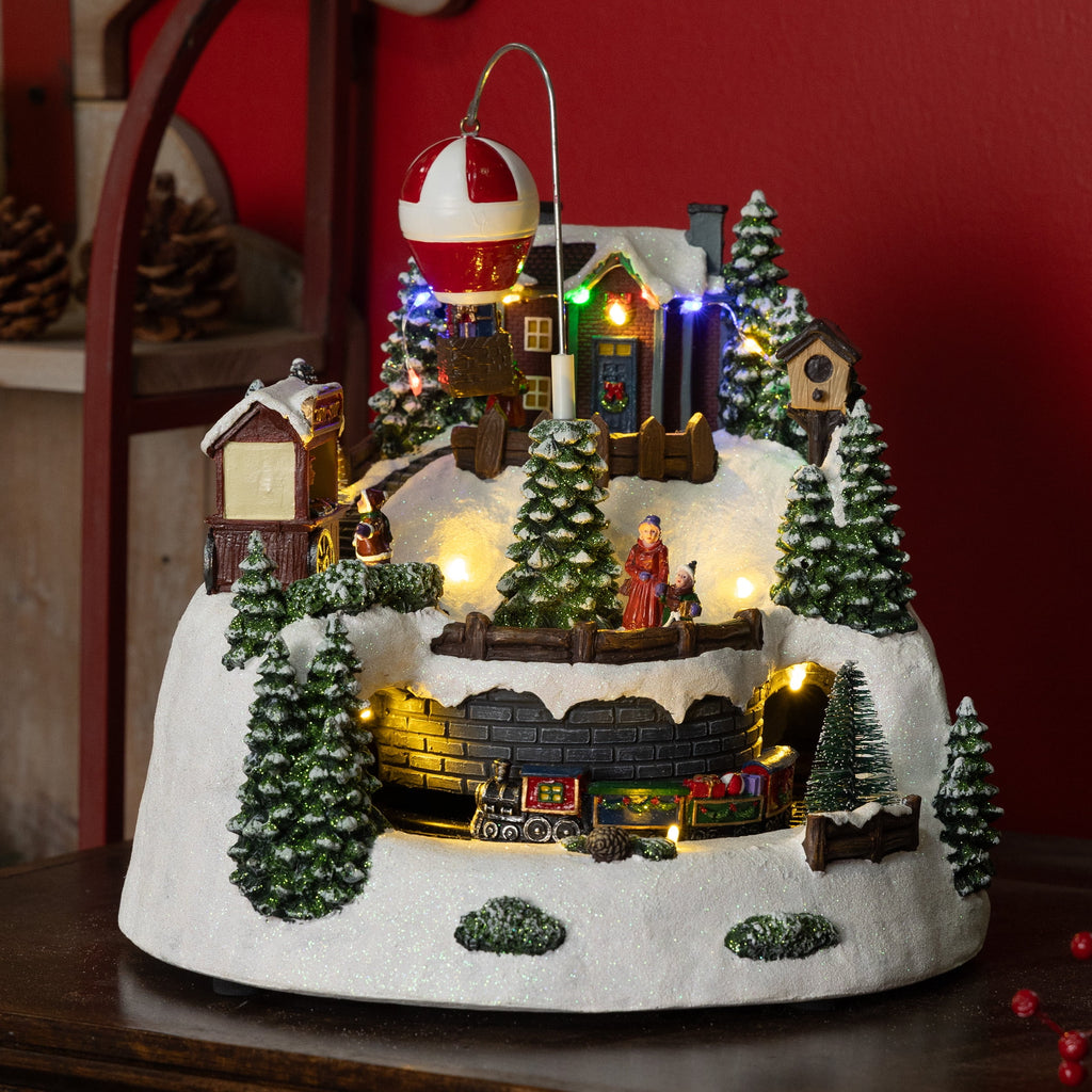 Alpine Corporation Animated Children Playing in Christmas Village Holiday Tabletop Decor with 26 Multicolor LED Lights and 5.9' Cord, 17" L x 11" W x 9" H